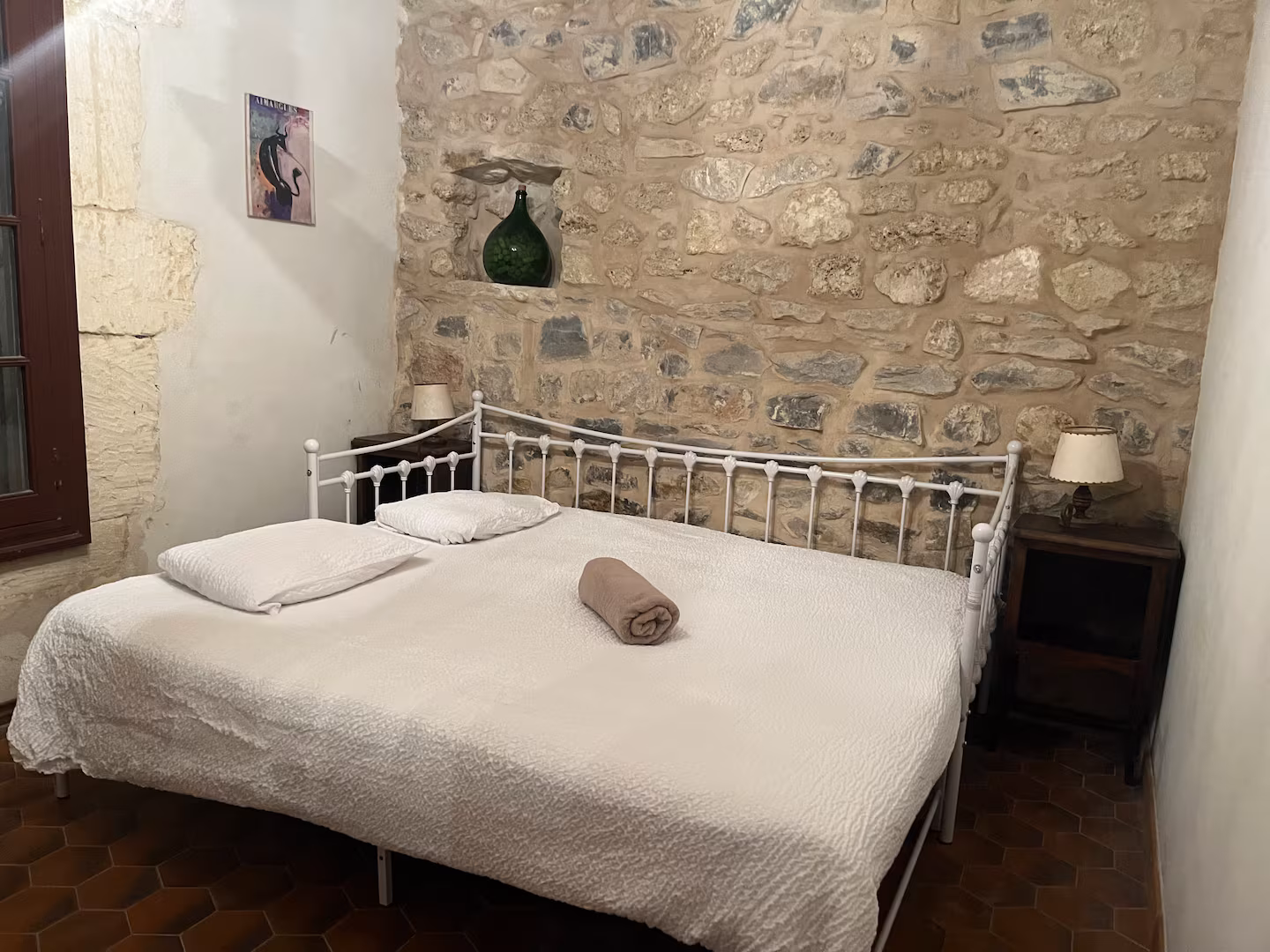 The Nook — ground floor bedroom with exposed stone, dark beams and king-size bed