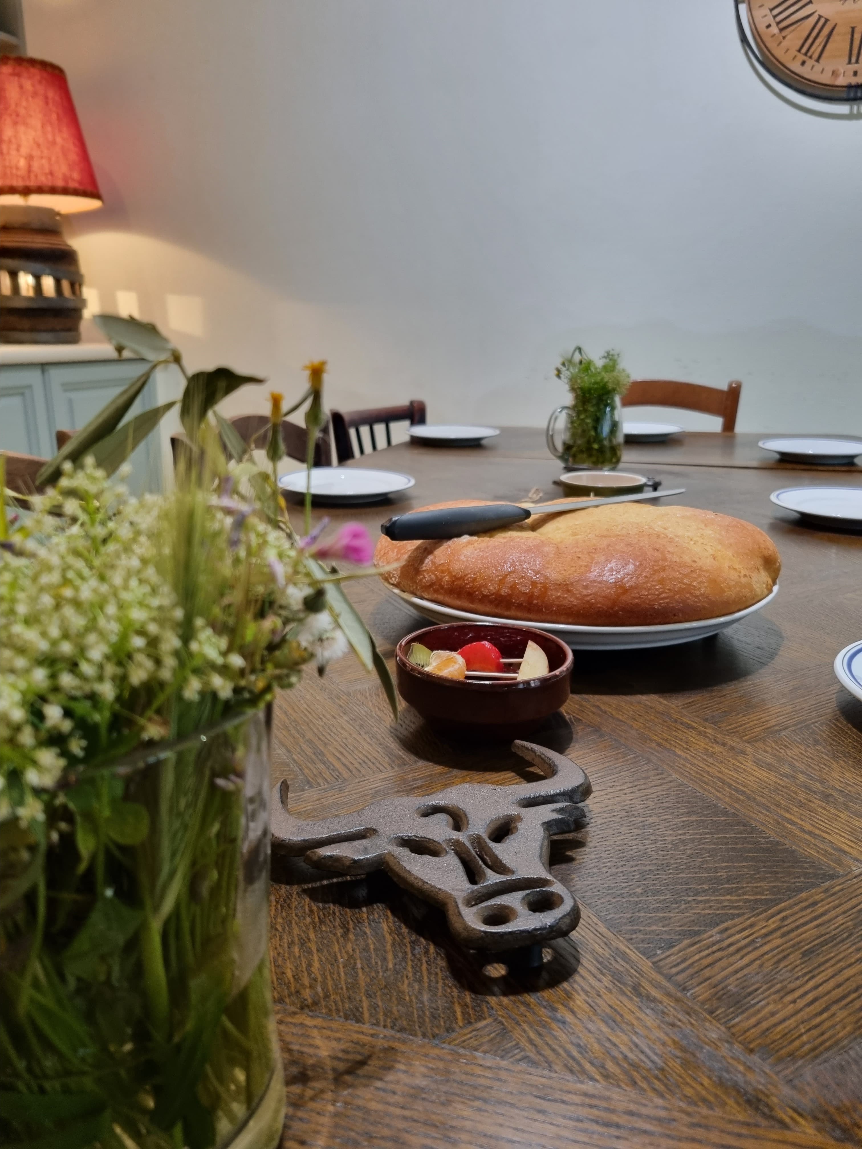 Dining table laid for breakfast with fresh brioche and wildflowers